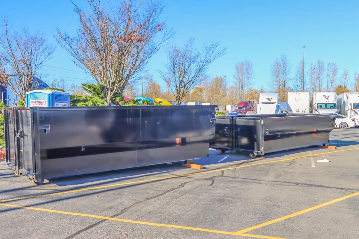 Professional dumpster rental service with roll-off container on residential driveway in Steilacoom